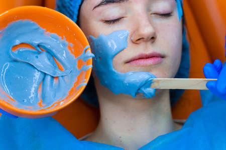 Alginate moisturizing mask for face and skin of young girl. Spa procedure for rejuvenation....