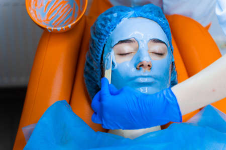 Alginate moisturizing mask for face and skin of young girl. Spa procedure for rejuvenation....