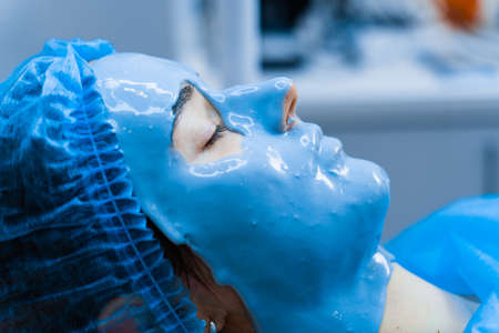 Alginate moisturizing mask for face and skin of young girl. Spa procedure for rejuvenation....