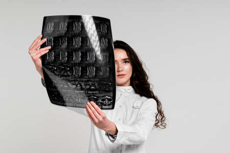 CT scan of the spine of a beautiful girl. Determination of the presence and degree of damage to bone and cartilage. Treatment of osteoporosis, osteomyelitis, osteochondrosis, intervertebral herniaの写真素材