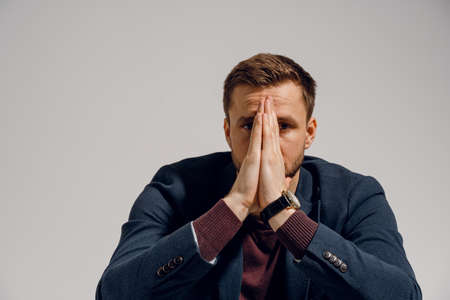 Sad man fell depression and stressed on white background. Emotional male.の写真素材