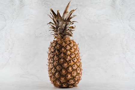 Pineapple tropical fruit on white stone background background. Citrus fruit with vitamin c for helth...