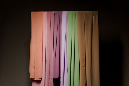 Multi-colored plain scarves on hangerの写真素材