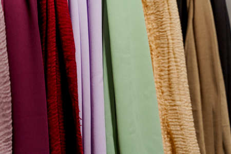 Silk scarf muslim. Multi-colored plain scarves on hangerの写真素材