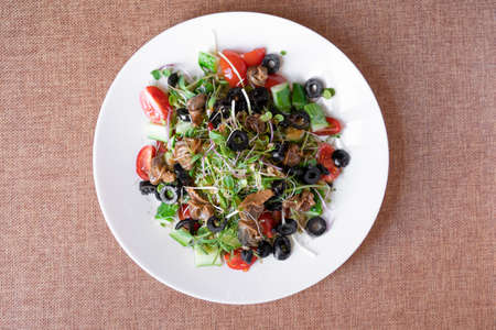 Salad with snail, olive, tomatoe cherie, cucumber and greens.の写真素材