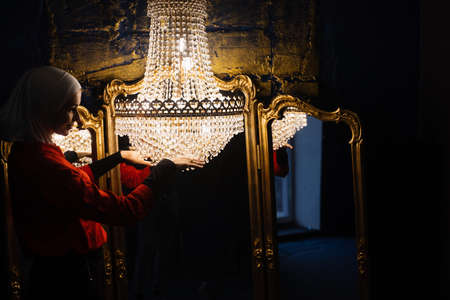 Fashion muslim model near big expensive chandelier. Islamic religion. Girl near mirrorsの写真素材
