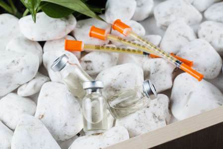 3 virus booster vaccines and syringes close-up. vaccinationの写真素材