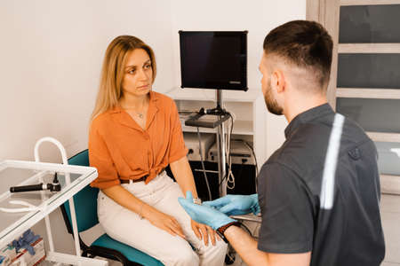 Woman visit ENT doctor. Consultation of woman with otolaryngologist in a medical clinicの写真素材