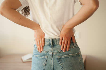 Attractive woman feel backache spine pain because of UTI pyelonephritis disease. Kidney infection pyelonephritis urinary tract infectionの写真素材