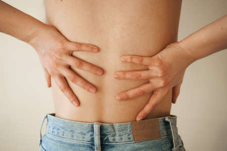 Kidney infection pyelonephritis urinary tract infection. Attractive woman feel backache spine pain because of UTI pyelonephritis diseaseの写真素材