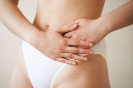 Stomach pain. Pancreatitis disease of pancreas becomes inflamed. Sick girl hold abdomen because it hurtsの写真素材