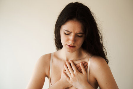 Heart attack disease of woman. Symptoms of angina pectoris. Attractive sick girl with heart ilness infarktの写真素材