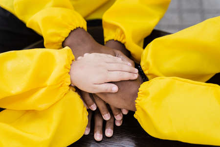 Multiracial children hands together forming pile close-up. Friendship of multinational kids. Childhoodの写真素材