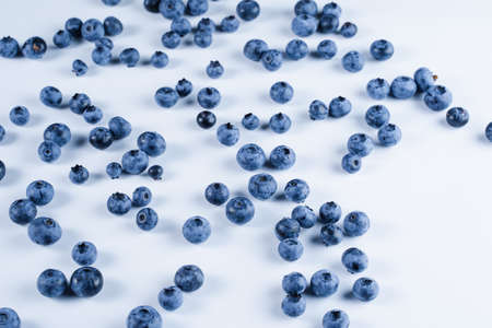 Blueberries with water drops on white background. Many blue berries on white tableの写真素材