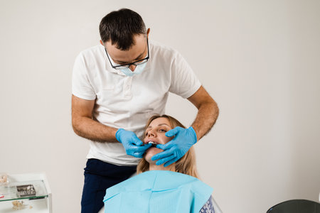 Doctor inserts impression tray and making cast of teeth to patient in dentistry before dental...