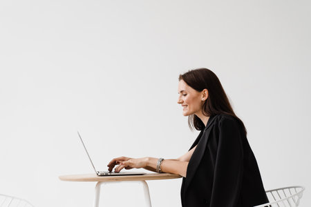 Girl manager with laptop have online video meeting with colleagues and business partners. Team discussion trends and tasks. Problem solving remotelyの写真素材