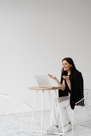 Popular girl blogger looks at statistics of her channel and enjoys lot of views of her videos. Happy...