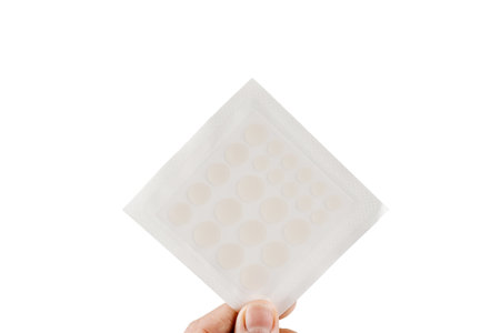 Top view of acne patch for facial rejuvenation. Set of round patches for acne in hand on white background. Facial cleansing cosmetologyの写真素材