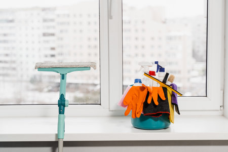 Housekeeping domestic cleaning service. Mop and bucket with detergent and gloves for house cleaning. Professional home cleaning serviceの写真素材