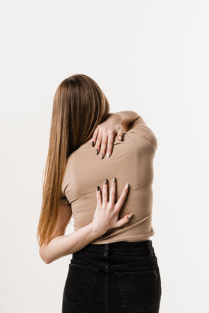 Cervical spine osteochondrosis is radicular syndromes of young woman. Attractive girl feel spine pain because of spinal nerves compressionの写真素材