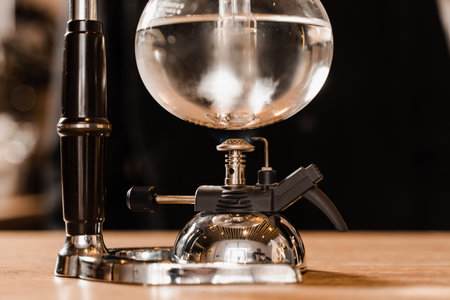 Process of boiling water in syphon device for alternative brewing coffee. Siphon vacuum pot for mixing coffee with boiling waterの写真素材