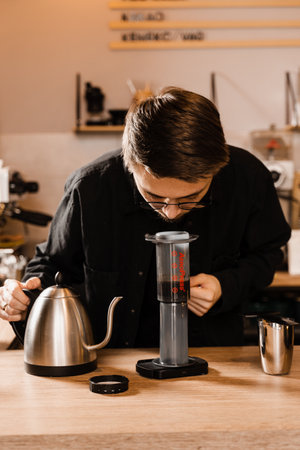 Barista sniff aeropress coffee aroma. Process of aeropress alternative method brewing coffeeの写真素材