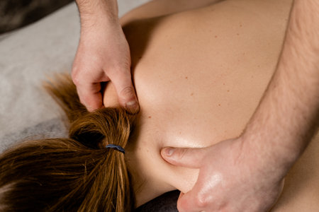 Classic massage close-up. Therapeutic massage with manipulating body to promote relaxation and reduce stress. Massage therapist use techniques such as friction, stretching, and tappingの写真素材