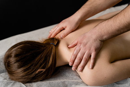 Classic massage close-up. Therapeutic massage with manipulating body to promote relaxation and reduce stress. Massage therapist use techniques such as friction, stretching, and tappingの写真素材