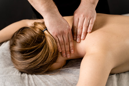 Classic massage close-up. Therapeutic massage with manipulating body to promote relaxation and reduce stress. Massage therapist use techniques such as friction, stretching, and tappingの写真素材