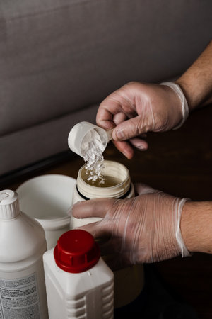 Cleaner mixes dry cleaning chemicals detergent with water to clean upholstered textile furniture and neutralize smellの写真素材
