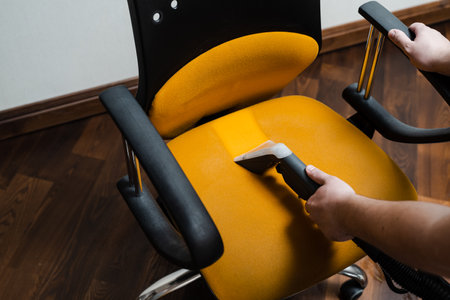 Line on armchair after dry cleaning with washing vacuum cleaner extractor machine. Domestic cleaning service cleaner is removing dirt and dust from chair using dry cleaning extraction machineの写真素材