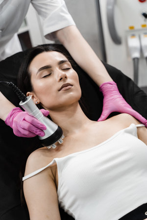 Tightening and rejuvenation of girl skin at cosmetology procedure. Thermal or radio frequency...