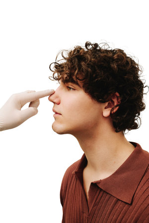 ENT doctor touching nose of patient before rhinoplasty or septoplasty surgery. Rhinoplasty to change...
