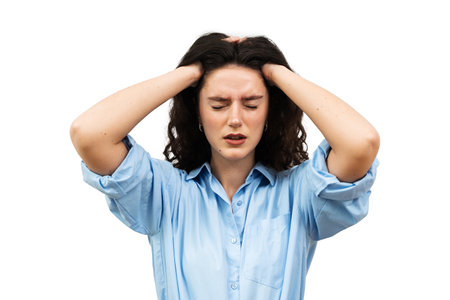Migraine is a strong headache of young woman. Overstressed woman touches her head because of pain....