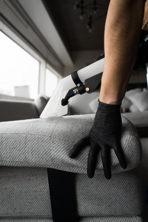 Extractor cleaning removes dust from the sofa at home. Dry-cleaning the upholstery furniture fibers...