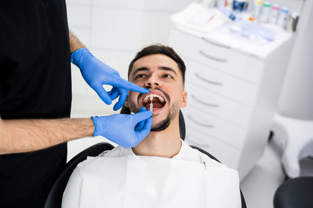 Analysis of patients tooth shade by dentist. Patient chooses tooth shade before bleaching
