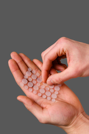 Acne pimple sticker to heal from inflamed zits on face. Dermatological acne patch to clean irritated skin from pimples. Effective nonmedical treatment for acneの写真素材