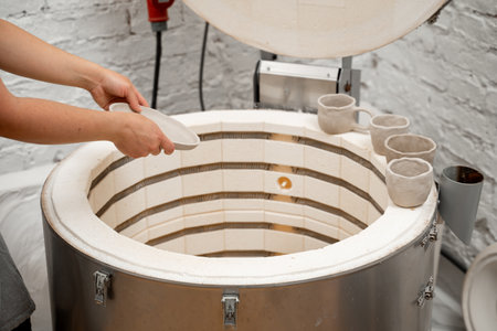 Heating pottery to extremely high temperature with isolation. Muffle furnace functioning. Putting...