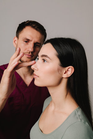 Rhinoplasty. Woman is going through nose surgery to remove dorsal hump. Rhinoplasty to improve appearance of noseの写真素材