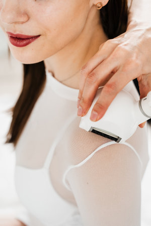 Lymphatic drainage massage of shoulder for a young woman. Improving the flow of lymph fluids to reduce swelling and increase wellbeing of the bodyの写真素材
