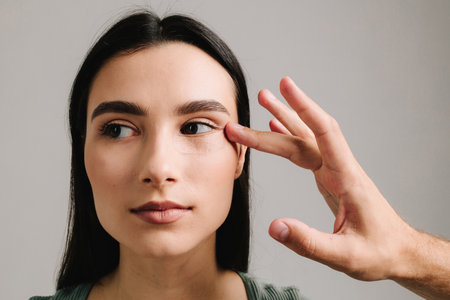 Eye lids surgery blepharoplasty to remove eye bags and cope with aging. Blepharoplasty. Woman is having post-op bandage to prevent bleeding and hide traces of surgical interventionの写真素材