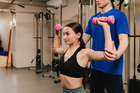 Doing kinesiology therapy to cardiovascular and pulmonary systems. Young woman is doing supervised...