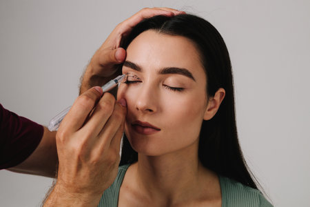 Blepharoplasty. Plastic surgeon is marking up contour for upper blepharoplasty. Drawing on skin of eyelids for accurate face lifting and safe surgery to remove excess skinの写真素材