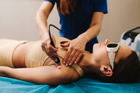 Infrared treatment of hand to manage pain, numbness and tingling. Doing laser therapy to improve blood flow and immune system. Hand low level laser therapy to promote healing of soft tissuesの写真素材