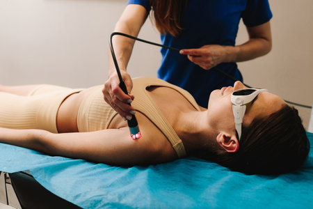 Hand low level laser therapy to promote healing of soft tissues. Infrared treatment of hand to...