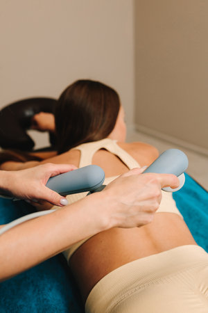 Tecar therapy for legs. Using electromagnetic energy to reduce pain and inflammation. Awakening body for faster healing response with diathermy. Painless leg rehabilitation after injuryの写真素材