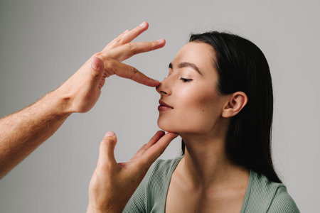 Rhinoplasty. Patient needs to alter bone, cartridge and reshape nose with rhinoplasty surgery. Young woman wants to change appearance of nose and improve breathingの写真素材