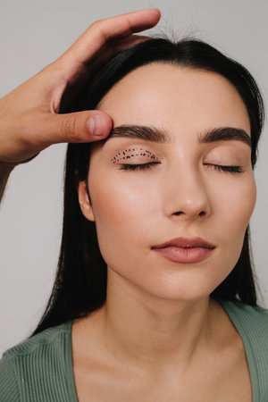 Blepharoplasty mark up. Lifting eye lids with precise planning. Doctor is drawing up plan for upper...