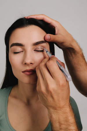 Blepharoplasty. Surgeon is marking up contour for upper blepharoplasty. Drawing on skin of eyelids...