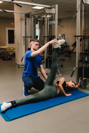 Preventing rheumatoid diseases with kinesiotherapy. Kinesiologist is assisting his female patient...